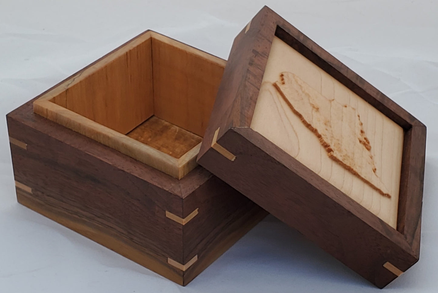 Walnut keepsake box or pet urn with a carved Maine top cover