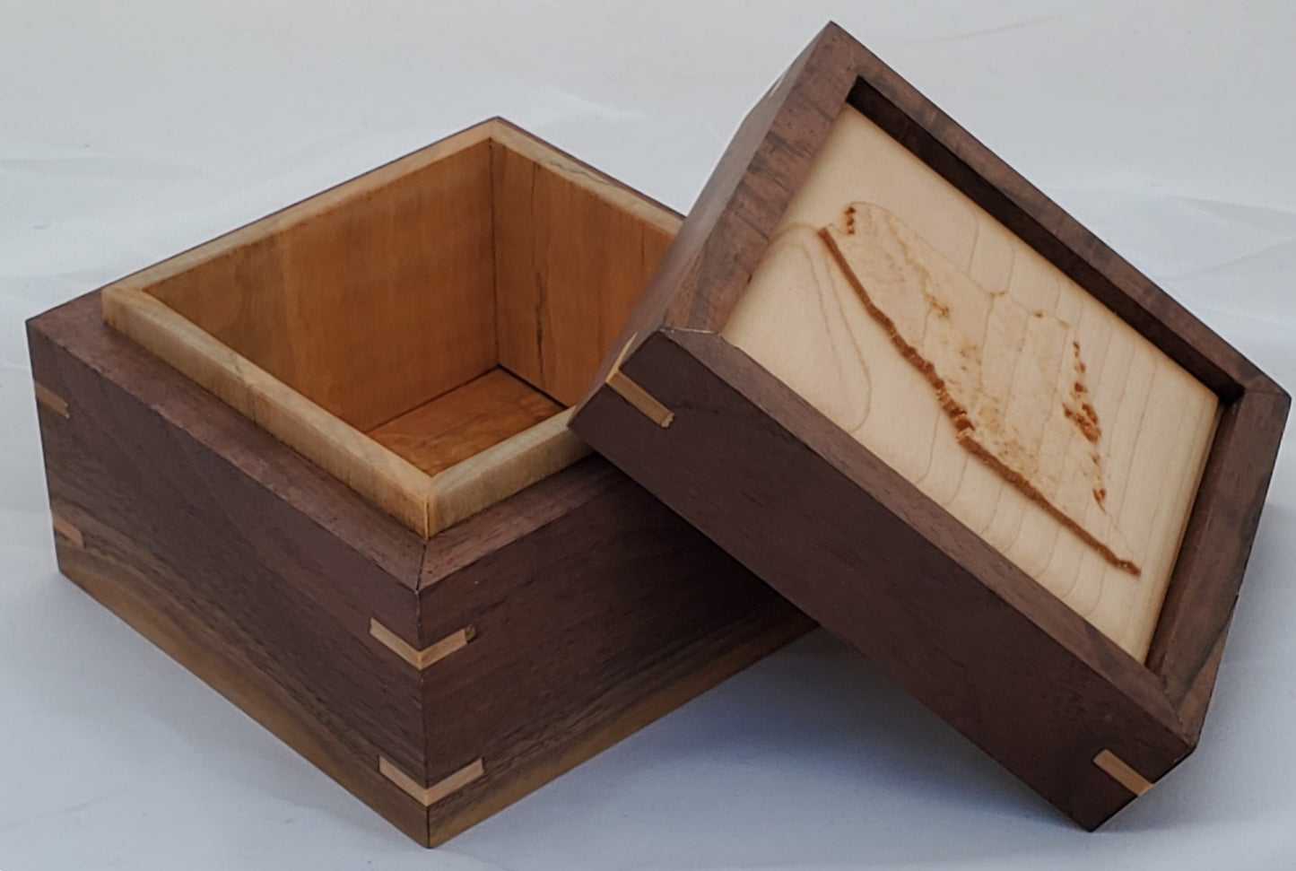 Walnut keepsake box or pet urn with a carved Maine top cover