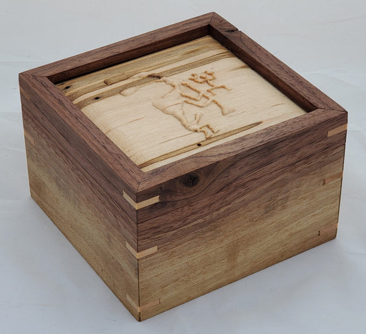 Walnut keepsake box or pet urn with a carved Kokopelli top cover