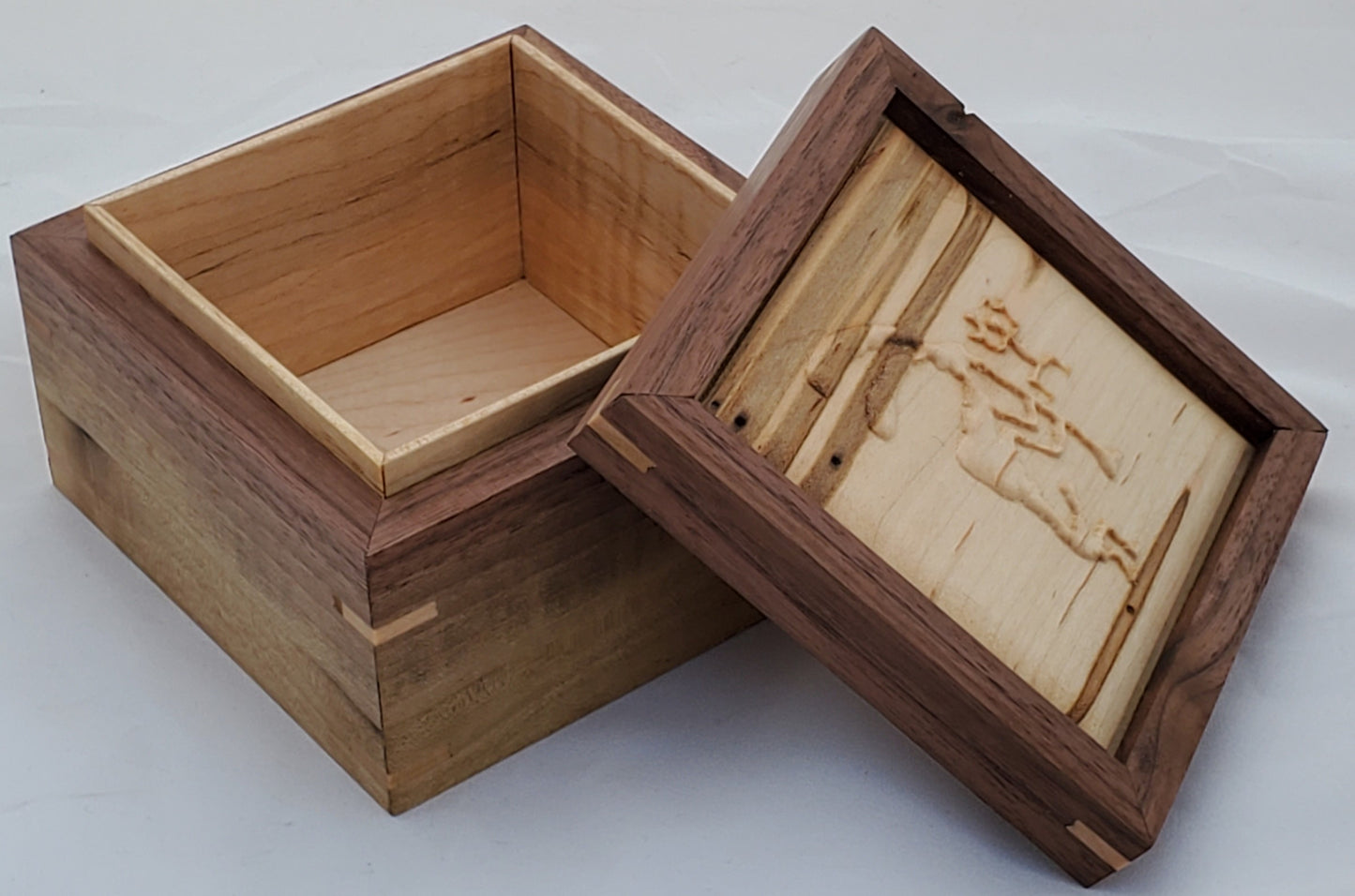 Walnut keepsake box or pet urn with a carved Kokopelli top cover